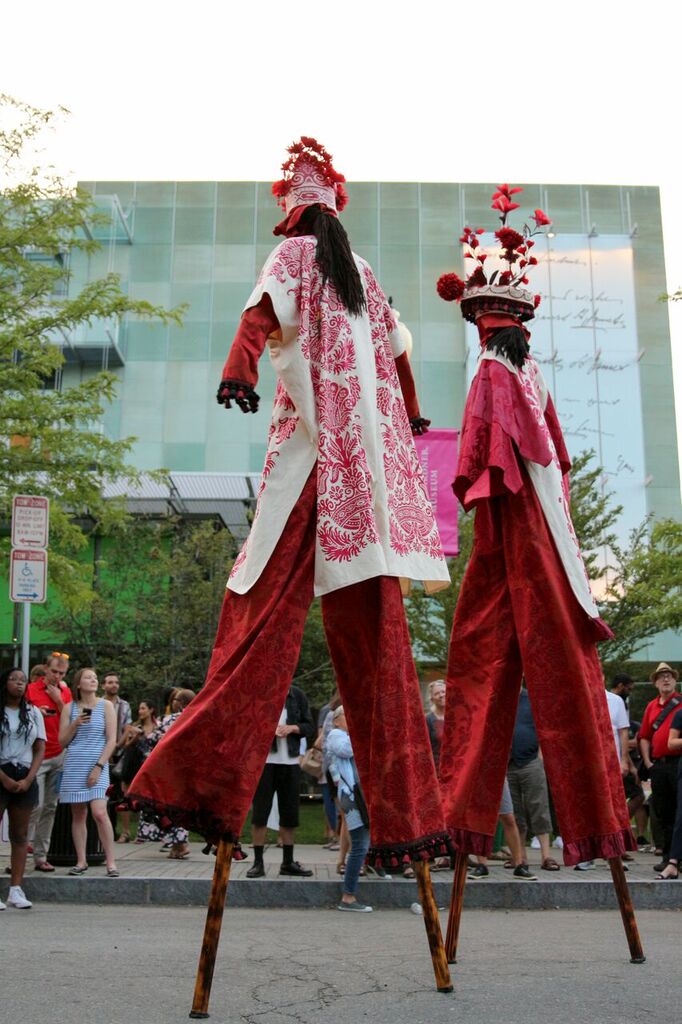 Audience of the Isabella Stewart Gardner Museum Welcomes dancers on stilts.